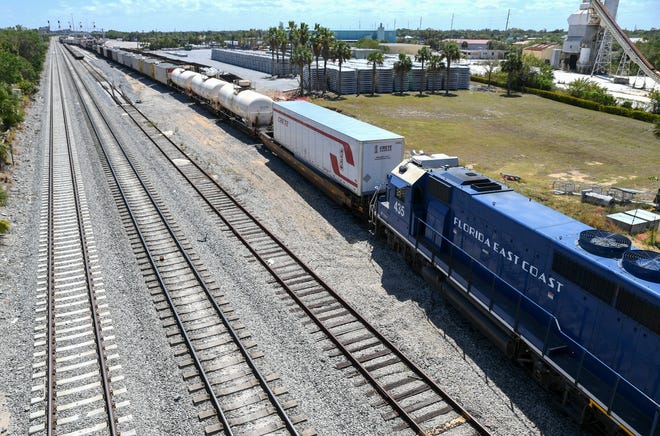 A Florida East Coast Railway locomotive moves several tank and cargo cars on a side track south of the Citrus Boulevard bridge Wedneseay, March 22, at the Florida East Coast Railway Fort Pierce Yard.