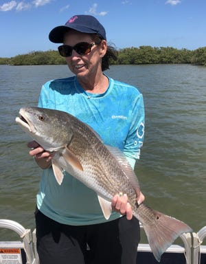 Robbie Mowery brought aboard (and then released) this large red while fishing with husband Art in the Indian River Lagoon.