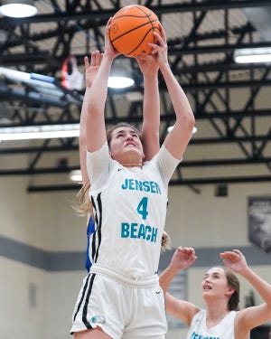 Jensen Beach's Lauren Cioffi (4) grabs a rebound in a girls basketball game against Martin County on Thursday, Dec. 15, 2022, at Jensen Beach High School.