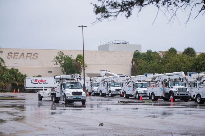 Dozens of Florida Power & Light trucks in the parking lot of the Boynton Beach Mall ahead of the arrival of Tropical Storm Nicole.