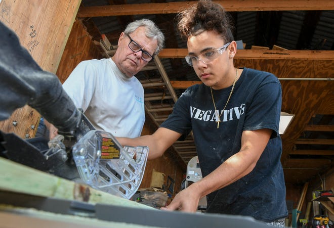 Keenan Ludwig, 17, (right) of Port St. Lucie, uses a tabletop saw to cut a plank of wood while learning carpentry skills from Project Lift instructor Eugene Theron, at the Project Lift facility on Thursday, Feb. 23, 2023, in Fort Pierce. "I feel like it helps others, it helps kids, I feel appreciative about being in this program," Ludwig said. Project Lift in Fort Pierce is one of dozens of projects in which Rep. Dana Trabulsy is seeking state money to support programs.