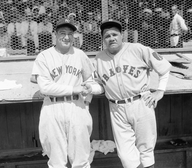Former New York Yankees teammates Babe Ruth, right, and Lou Gehrig pose together at a spring training game in St. Petersburg, Fla., March 16, 1935 as they met for the first time after Ruth left the Yankees for the Boston Braves.  The Braves defeated the Yankees 3-2 in the exhibition game.