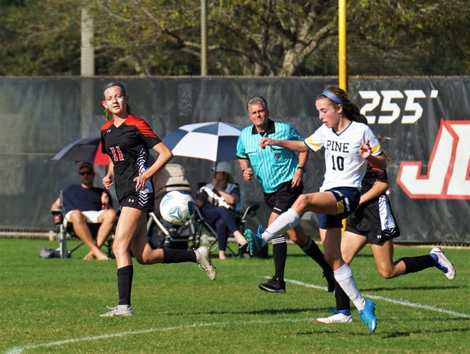 Pine School's Hope Katz clears the ball against Jupiter Christian during the District 8-2A championship match on Tuesday, Jan. 31, 2023 in Jupiter. Pine School won the match 3-2.