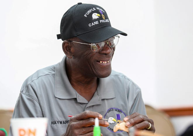 Ervin Hayward, of Port St. Lucie, secretary of the Purple Heart Cane Project, carves a piece of bass wood during a gathering of veterans and civilians who meet every Tuesday at the Spanish Lakes Fairways on Tuesday, April 4, 2023, in Fort Pierce.