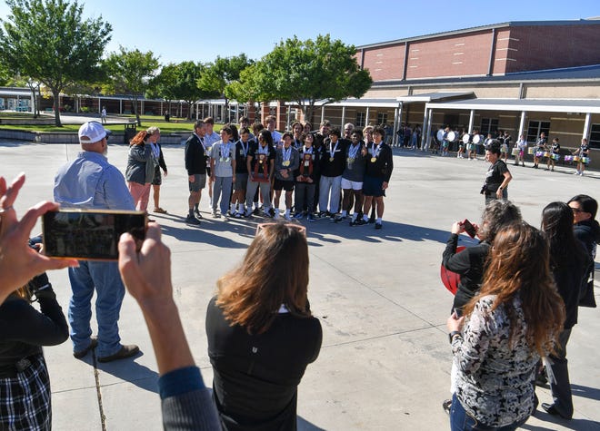 Students, faculty and family congratulate the Jensen Beach boys wrestling 1A state champions in the school's courtyard, Tuesday, March 21, 2023.