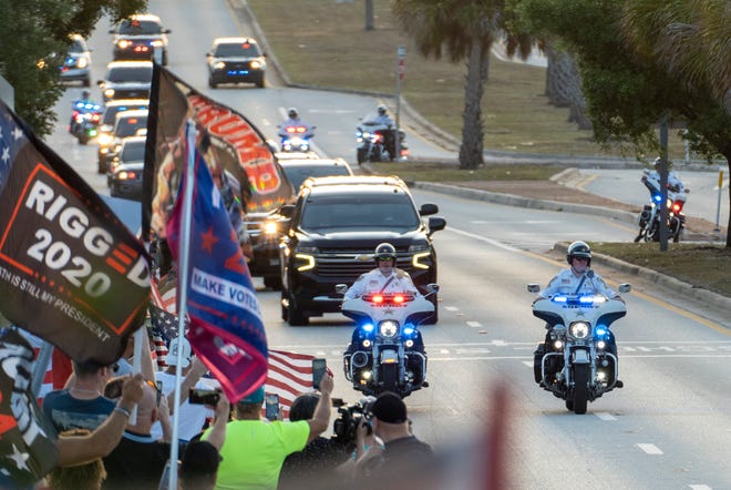 Former President Donald Trump waves to supporters from his motorcade as he returns to Mar-a Lago following his arraignment in New York on April 4, 2023.
