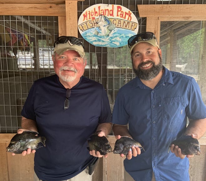 Junior Johnson (from DeLand) and Steve Sbarra (Cocoa Beach), at Highland Park in DeLand, with a handful of the limit of bluegill they caught in Norris Dead River.