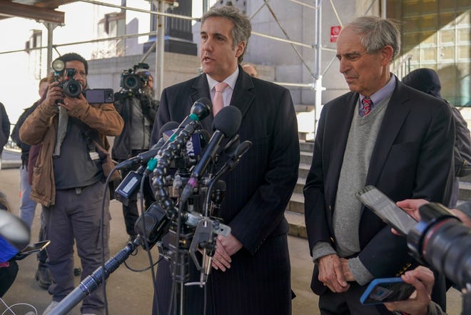 Donald Trump's former lawyer and fixer Michael Cohen, center, is joined by his attorney Lanny Davis on March 15 in New York.