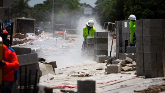 Construction crews work on a project at the corner of Fowler and First Street and Second Street in Fort Myers on Monday, June 13, 2022. The site will become an apartment complex.