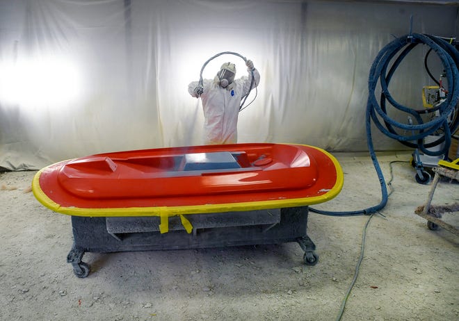 Raheeem Hall, a gel coat tech, sprays a layer of gel onto a hard top mold for a Maverick sport fishing boat at the Maveric Boat Group assembly plant across from the St. Lucie International Airport on Tuesday, Sept. 20, 2022, in Fort Pierce. "It feels wonderful it feels great, I love the opportunity," Hall said. "The experience we have, that they have given me, everything is great."