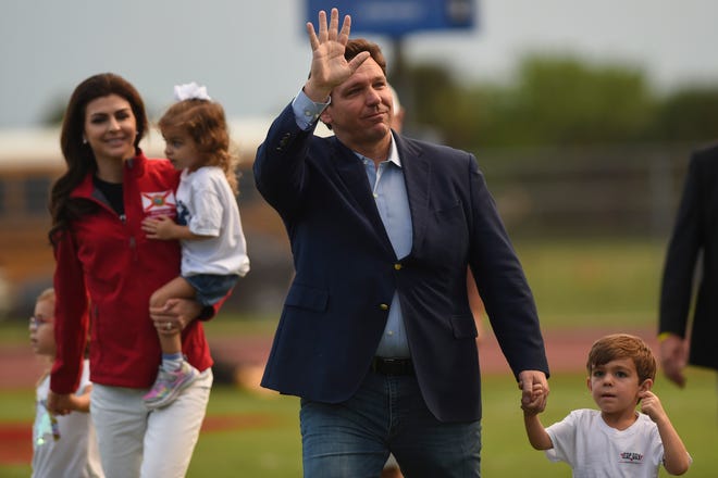 Gov. Ron DeSantis, his wife Casey DeSantis and their three children wave to a crowd at Shark Stadium on Friday, Sept. 23, 2022, before Vero Beach played Miami Palmetto. The football game, originally to be held at Billy Living’s Football Field, was moved to Shark Stadium due to the conditions of Vero's field.