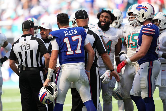 Bills quarterback Josh Allen yells at the officials who penalized him after he went after Dolphins defensive lineman Christian Wilkins (with helmet off) for allegedly grabbing his groin during the second half of their game on Sept. 25.