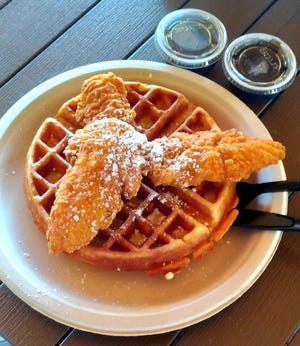 The Chicken & Waffles served with warm syrup is a perfect choice for a savory/sweet start to the day.