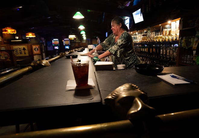 Pollyanne Wester, bartender at the Boozgeois Saloon, cleans the counter while working her shift on Thursday, Aug. 11, 2022, in Fort Pierce. "Good friends, good people come in," Wester said. "It's a nice bartending job it's a good place to work People are really friendly, I enjoy my day here."