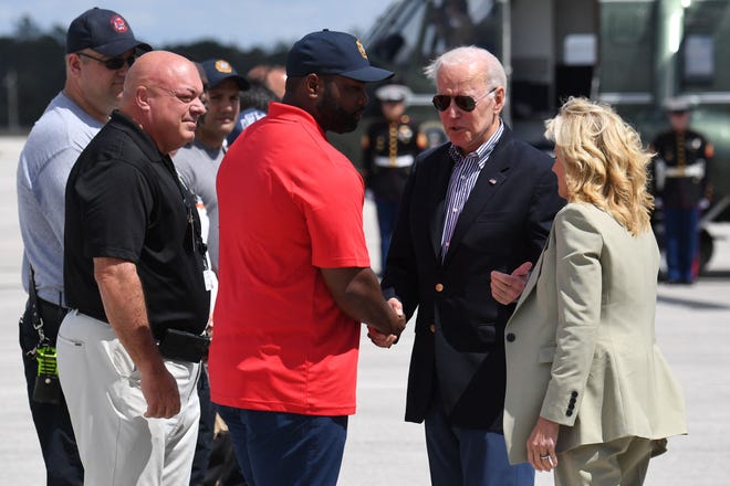 US President Joe Biden and US First Lady Jill Biden are greeted by US Representative Byron Donalds (R-FL) upon arrival at Southwest Florida International Airport in Fort Myers on Wednesday. The president and first lady traveled to Fort Myers to survey the storm-ravaged areas and meet with small business owners and state officials.