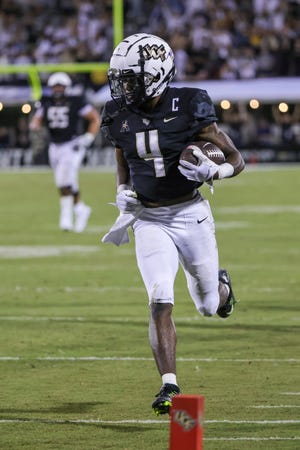 Oct 5, 2022; Orlando, Florida, USA; UCF Knights wide receiver Ryan O'Keefe (4) scores during the second half against the Southern Methodist Mustangs at FBC Mortgage Stadium. Mandatory Credit: Mike Watters-USA TODAY Sports