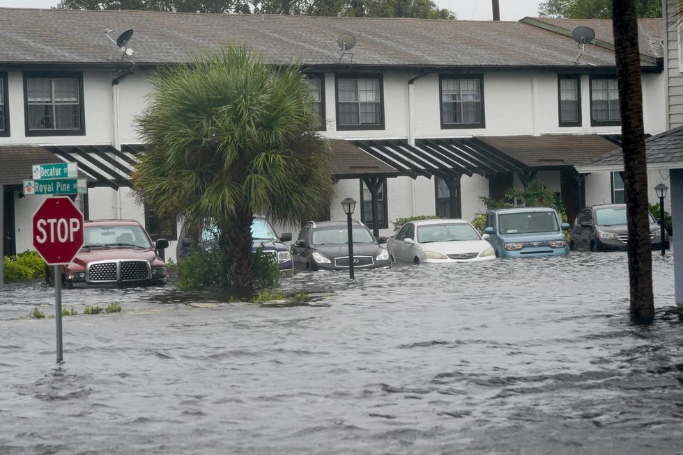 Vehicles sit in flood water at the Palm Isle apartments in the aftermath of Hurricane Ian, Thursday, Sept. 29, 2022, in Orlando, Fla. Hurricane Ian carved a path of destruction across Florida, trapping people in flooded homes, cutting off the only bridge to a barrier island, destroying a historic waterfront pier and knocking out power to 2.5 million people as it dumped rain over a huge area on Thursday. (AP Photo/John Raoux)