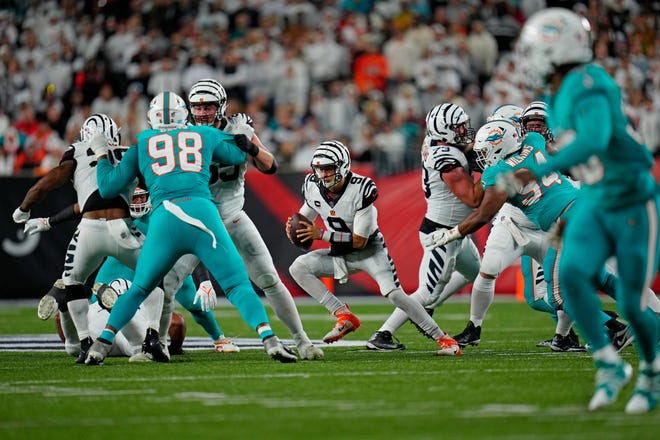 Bengals quarterback Joe Burrow cuts right on a keeper against the Dolphins defense during last Thursday's game in Cincinnati.