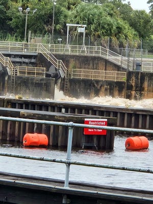Discharges pour out of flood gates at St. Lucie Lock and Dam on Sept. 28, 2022.