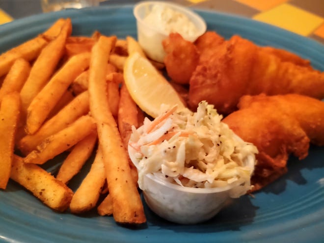 Three beer-battered fish filets were deep-fried and served piping hot with tartar sauce, Old Bay-seasoned French fries and a cup of tangy coleslaw.