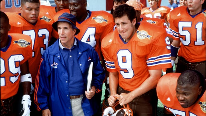 Sandler went on to be a top box office draw in slapstick comedies including the 1998 film "Waterboy" with Henry Winkler, left.