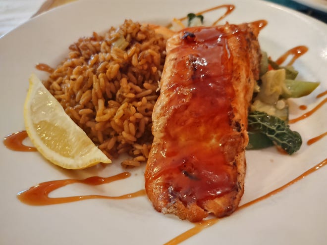 A nice portion of salmon was grilled to perfection and drizzled with citrus teriyaki sauce.
