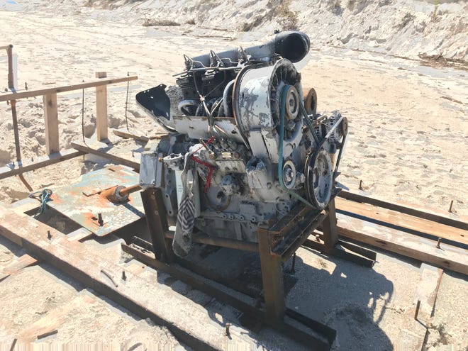 What appears to be an older model motor engine was afixed atop wooden boards that enclosed the plastic foam of a handmade boat, immigration and Coast Guard officials say was likely a migrant vessel. It grounded north of Jaycee Beach Park sometime early Wednesday, Oct. 5, 2022.