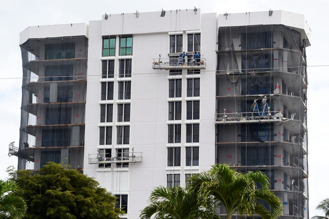 Construction crews work on restoring the aging concrete on the exterior of the Barclay Beach Club condominiums in St. Lucie County on Wednesday, Jan. 5, 2022.