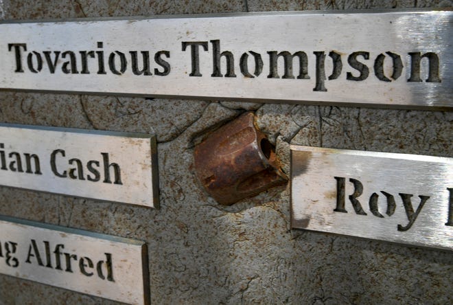 The Memorial Wall of Prayer & Hope features names of those killed by violence along with pieces of handgun components and knives mixed in to the wall suspended above a small garden area in front of a circle of brick pavers, as seen on Thursday, Aug. 4, 2022, in Fort Pierce.