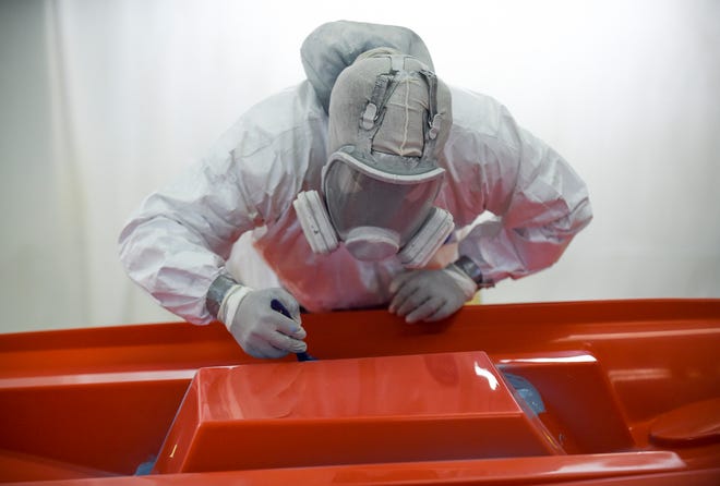 Raheeem Hall, a gelcoat tech, uses a paint brush to apply the gel to a hard to reach area on a hard top mold for a Maverick sport fishing boat at the Maveric Boat Group on Tuesday, Sept. 20, 2022, in Fort Pierce. "I gelcoated before I went back and got my certificate for gelcoat, for boat repair, and now I'm back at boats again," Hall said.