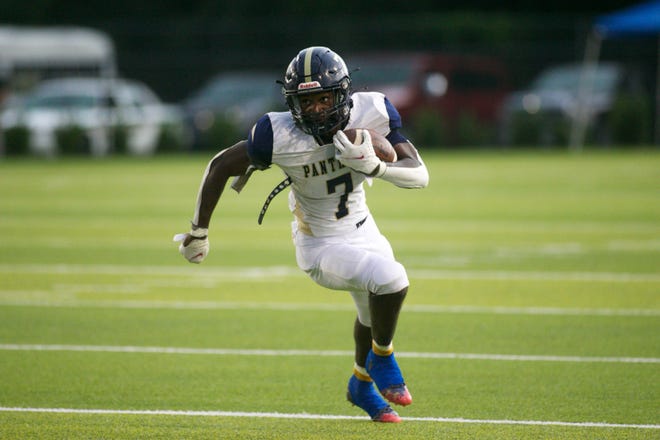 St. John Paul II junior running back Jadan Walden (7) rushes the ball downfield in a game against Rickards on Aug. 25, 2022, at Gene Cox Stadium. The Panthers won, 35-33.