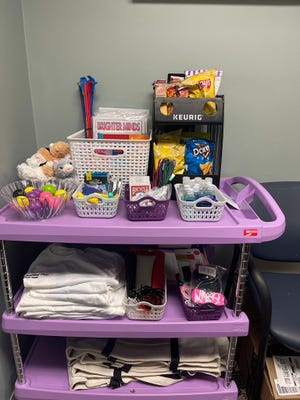 This Monday, Oct. 3, 2022, photo shows a "code lavender" cart that Cleveland Clinic Florida uses to deliver goodies to patients and their families who have been transferred from Southwest Florida hospitals due to Hurricane Ian.