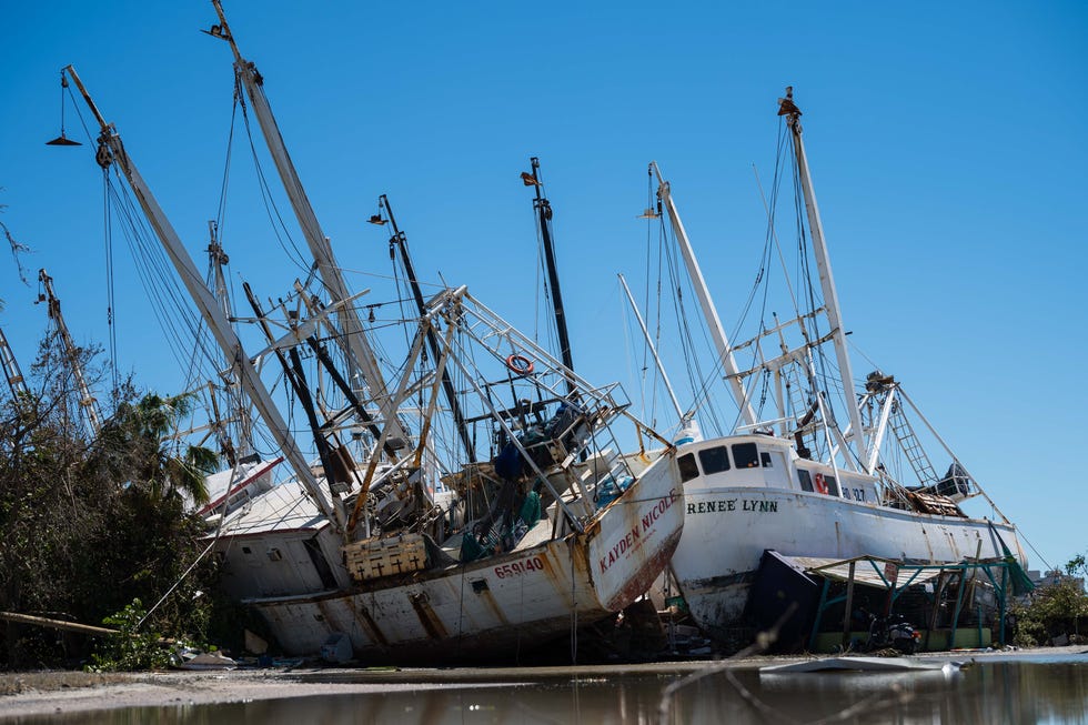 A pair of shrimp boats are seen beached on shore near Trico Shrimp Company on San Carlos Island after Hurricane Ian passed through the region Wednesday afternoon in Fort Myers, FL., on Friday, September 30, 2022.