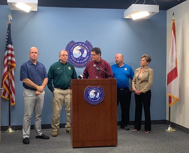 Todd Reinhold (second from right) attended a news conference April 5, 2019.