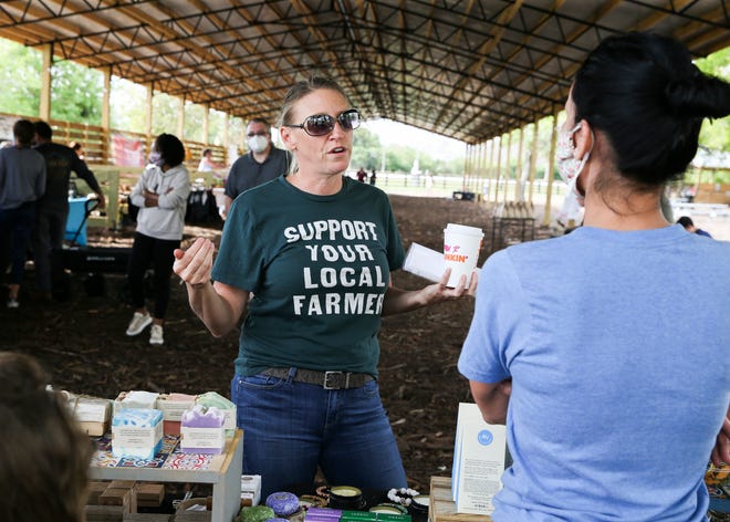 Market manager Beth Leonard (left) speaks with vendor Emily Mauri, of JAR The Zero Waste Shop, during the Hobe Sound Farmers Market on Saturday, March 6, 2021.