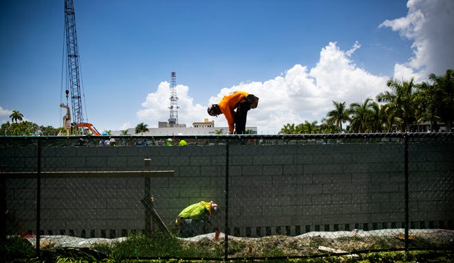 Construction crews work on a project at the corner of Fowler and First Street and Second Street in Fort Myers on Monday, June 13, 2022. The site will become an apartment complex.