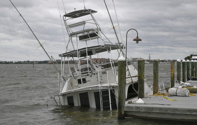 Four boats were sinking or already sunk, as seen on Thursday, Sept. 29, 2022, at the Causeway Cove Marina in Fort Pierce, Fla. Unexpected strong wind gusts from Hurricane Ian caused damaged to boats and docks.