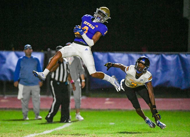 Cardinal Newman wide receiver Nae’Shaun Montgomery (3) catches a fourth quarter touchdown pass over John Carroll defensive back Robert Jones during the fourth quarter of a 40-7 victory Monday night in West Palm Beach.