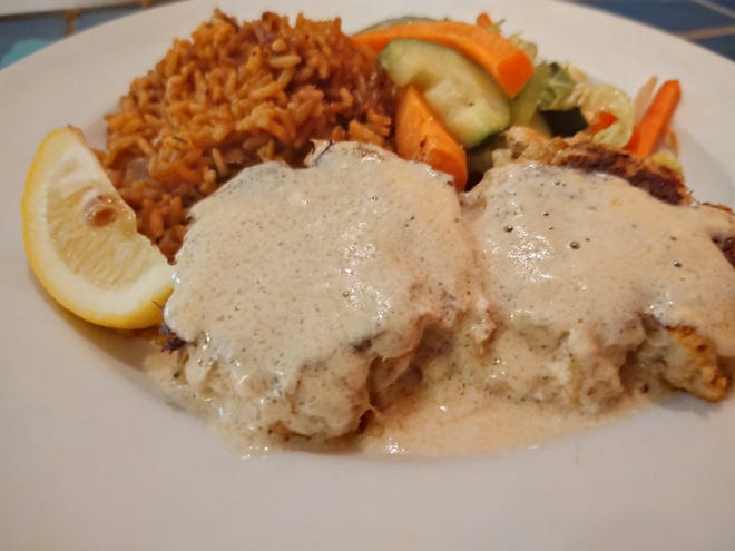 Two lovely pan seared crab cakes were topped with citrus buerre blanc and served with rice and a medley of fresh steamed vegetables.