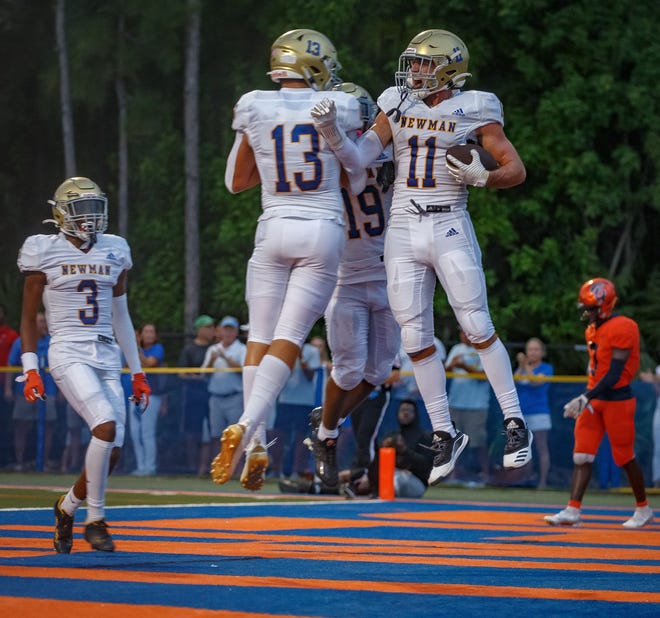 Crusader Chris Presto (11) celebrates his touchdown reception during first half action as The Benjamin School Buccaneers hosts the Cardinal Newman Crusaders during Florida High School Athletic Association boys football action at Theofilos Field at The Benjamin School in Palm Beach Gardens, Fla., on September 9, 2022.