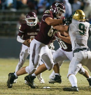 OL Joe Hanson clears the way during the Niceville Nease regional playoff football game at Niceville. Nease advanced with a 24-19 win.