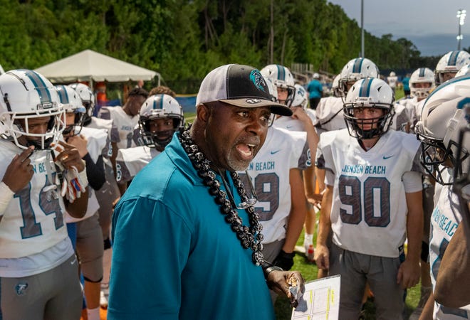 Jensen Beach Head Football Coach Tim Caffey talks to his players at halftime during game against Benjamin in Palm Beach Gardens on September 22, 2022.