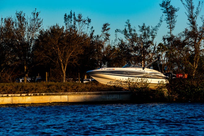 A boat sits on the shore of Cape Coral after Hurricane Ian on Oct. 2, 2022.