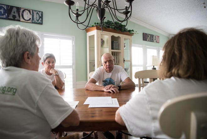 Richard Sullivan (center) and wife Kathey (far left) host neighbors and fellow members of The Sierra Club, Elaine Lavallee (right) and June Downs, at their home July 16, 2019, in the Indianwood Golf & Country Club in Indiantown. They meet to address sugar cane field burning. "We enjoy the people, we enjoy the climate; unfortunately, we've been subjected to the air pollution," Richard Sullivan said. "If we're in the wrong end of which way the wind is blowing, we're subjected to the smoke from the burning ... and also the ash that gets all over everything."