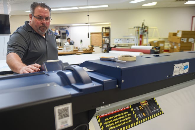 James Warden, of Port St. Lucie, a graphic designer and production specialist, designs artwork for a client at FastSigns, a signage company in Port St. Lucie on Monday, Aug. 29, 2022. "It's a fun business," Warden said. The franchise opened in August and provides services to help retailers in the area.