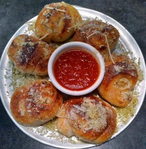 An order of six garlic knots were buttery and served with an exceptional red sauce.