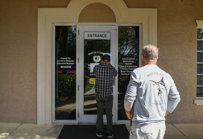 Customers of the Martin County Tax Collector Office walk up to a locked door an advisory letter about network issues, at the Willoughby Commons office, leaving them to unable to update their license plates on Monday, Nov. 1, 2021 in Stuart.
