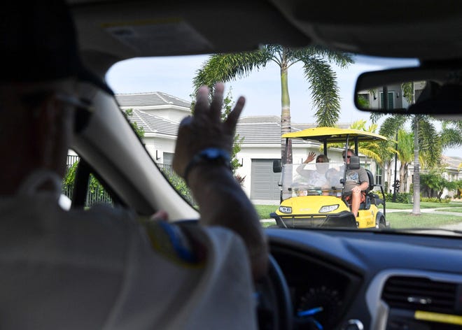Port St. Lucie police volunteer Harvey Hager, 75, waves to community members while patrolling the Valencia Cay community, Thursday, Nov. 17, 2022. Hager is among about 165 volunteers that provide community patrol, parking enforcement, courier services and investigative help.
