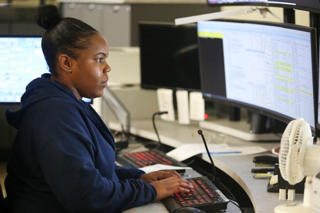 Chiquita Reese, 32, of Fort Pierce, works at the St. Lucie County Emergency Operations Center in Fort Pierce on Thursday, Nov. 17, 2022. The communications training officer has worked at the center for five years, where the staff are cross-trained in different departments to fill in when needed. “You have to stay calm,” Reese said of taking stressful calls. “You have to think about the safety of them and your officers.”