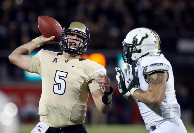 Central Florida quarterback Blake Bortles (5) is pressured by South Florida defensive lineman Aaron Lynch (19) during the first half of an NCAA college football game on Friday, Nov. 29, 2013, in Orlando, Fla.